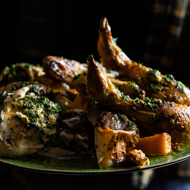 A whole roasted chicken with garlic, shallots, herbs, butternut squash, and treviso chicory.