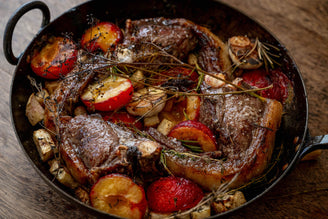 A pan of Roast Cull Yaw Mutton Chops with Celeriac & Plums.