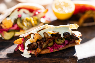 Loaded Mutton Kebabs with vegetables, herbs, and a yoghurt sauce.