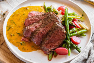 Cafe de Paris Hollandaise with grass fed beef Rib Eye Steak & Spring Vegetables