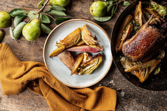 A plate of cooked wild mallard with hispi cabbage and pears.