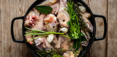 A pot of properly free range chicken offal and bones with herbs and vegetables