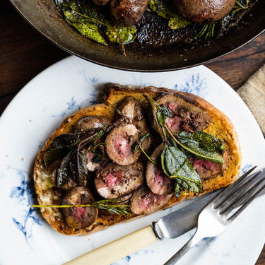 A meal of cooked Grass Fed Lamb Offal on toast with herbs.