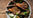 A meal of cooked Grass Fed Lamb Chops with vegetables and herbs.