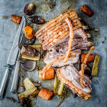 A whole cooked native breed pork belly with apples