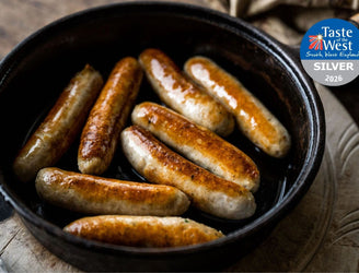 Cooked Free-Range Chicken Sausages In A Pan, Offering A Healthy And Lean Option For A Wholesome Meal.