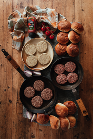 A Spread of Raw Burgers and Seeded Burger Buns For Summer Barbecuing 