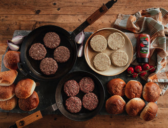 A Spread of Raw Burgers and Seeded Burger Buns For Summer Barbecuing 
