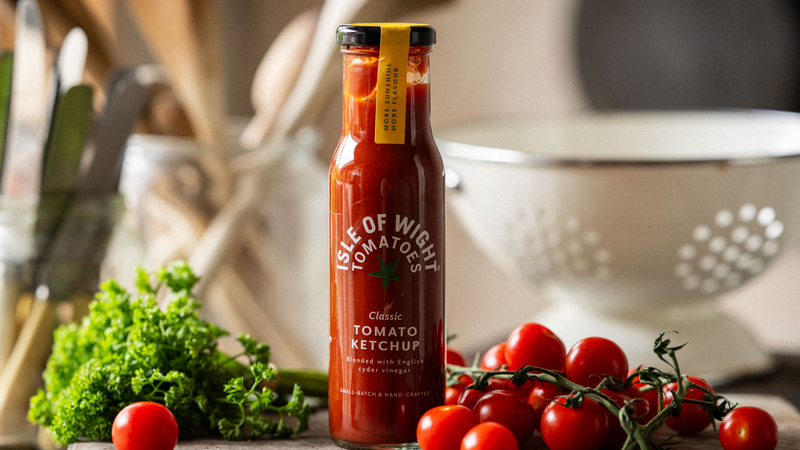 A bottle of Isle of Wight, Classic Tomato Ketchup with tomatoes and parsley.