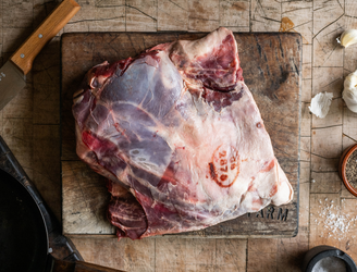 A whole, raw, wild venison shoulder.