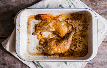 A pair of cooked, properly free range chicken legs.