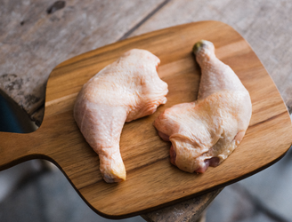 A pair of raw, properly free range chicken legs.