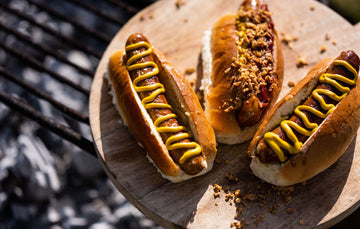 Fowlescombe Rare and Pasture, pasture fed pork frankfurter hot dogs with mustard and onions.