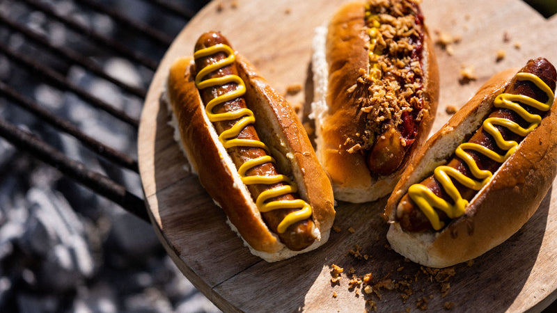 Fowlescombe Rare and Pasture, pasture fed pork frankfurter hot dogs with mustard and onions.