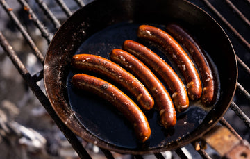 Fowlescombe Rare and Pasture Ltd Organic Grass Fed Beef Curry Frankfurters cooking in a pan.