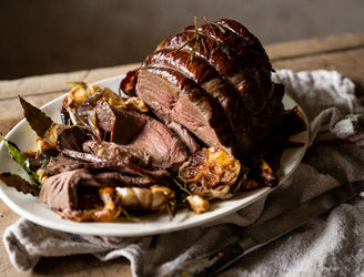 A cooked and sliced wild venison haunch