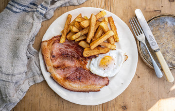 Native breed smoked gammon pork steak with a fried egg and chips.