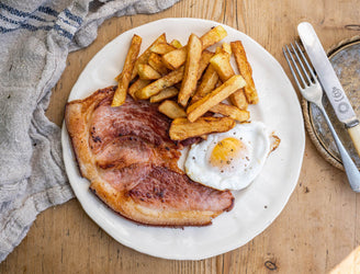 Native breed smoked gammon pork steak with a fried egg and chips.