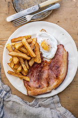 Native breed smoked gammon pork steak with a fried egg and chips.
