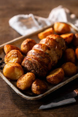 A cooked properly free range boneless turkey leg with roast potatoes