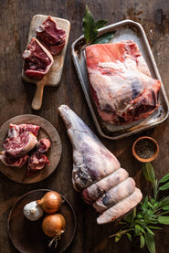 A selection of raw cuts of Cull Yaw Mutton with onions, garlic and herbs.