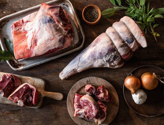 A selection of raw cuts of Cull Yaw Mutton with onions, garlic and herbs.