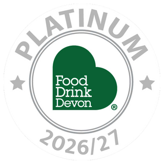 A circular badge reading PLATINUM around the border, with the Food Drink Devon logo in the center and 2026/27 below, on a white background.