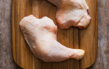 A pair of raw, properly free range chicken legs.