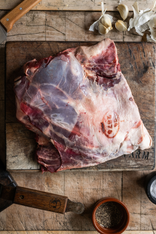 A whole, raw, wild venison shoulder.