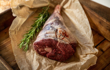 A raw, grass fed, leg of Cull Yaw Mutton with rosemary.