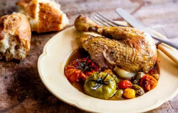 Cooked, properly pastured chicken with tomatoes, garlic, onions, and bread.