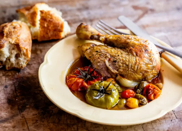Cooked, properly pastured chicken with tomatoes, garlic, onions, and bread.
