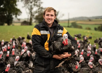 Mark, the farmer, holding a properly free range turkey.