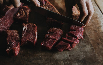 Raw Grass Fed Braising Beef being diced