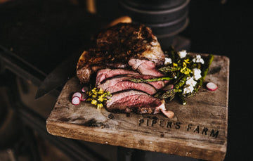 Cooked Butterflied Leg of Lamb Served With Asparagus, Feta Cheese and Radish. 