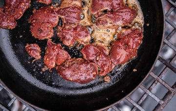 Ethically Raised, Slow Grown Free Range Chicken Livers cooking in a pan with chilli flakes and seasonings.