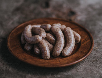 Cooked Free-Range Chicken Sausages In A Pan, Offering A Healthy And Lean Option For A Wholesome Meal.