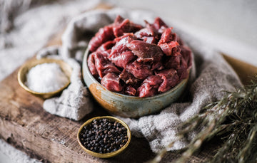 A bowl of ready to cook raw Cull Yaw Diced Mutton with salt and pepper.