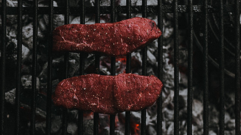 100% grass fed Beef Entrecote Steaks Grilling On An Open Flame Barbecue.