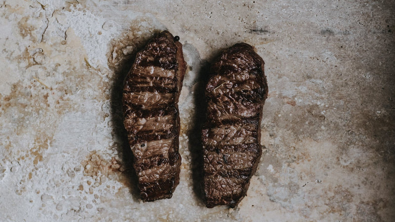 Resting Cooked Grass Fed Beef Entrecote Steaks, Perfect Paired With Frites and a Glass of Bordeaux.