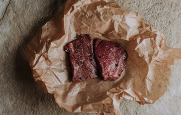 Two raw grass fed beef everyday steaks with seasoning