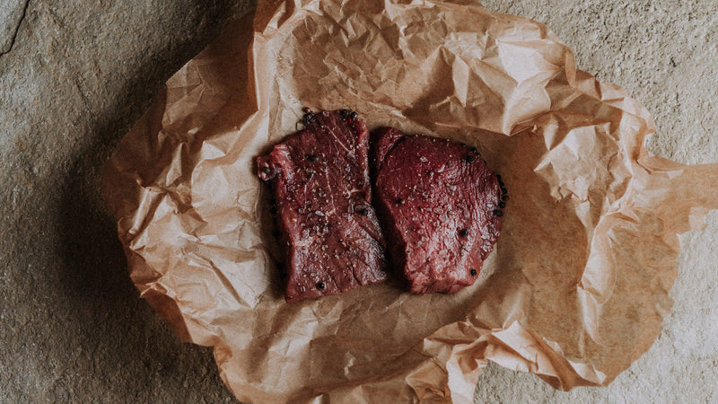 Two raw grass fed beef everyday steaks with seasoning