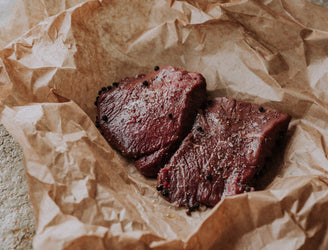 Two raw grass fed beef everyday steaks with seasoning