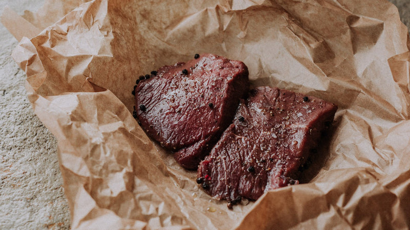 Two raw grass fed beef everyday steaks with seasoning