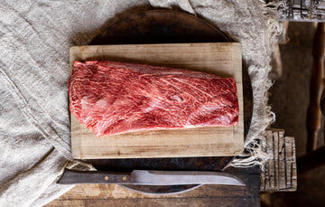 A raw, whole grass fed beef flat iron steak