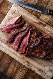 Cooked and sliced rare, grass fed beef flat iron steak