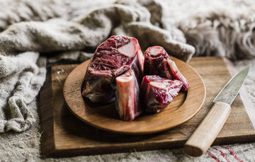 A plate of raw Grass Fed Mutton Osso Buco.