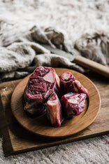 A plate of raw Grass Fed Mutton Osso Buco.