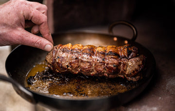 A cooked, grass fed, Cull Yaw Mutton Loin sizzling in a pan.