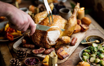 A whole cooked properly free range cockerel being sliced